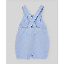 Light blue knitted dungaree for newborns with crossed straps, featuring a textured fabric and soft design.