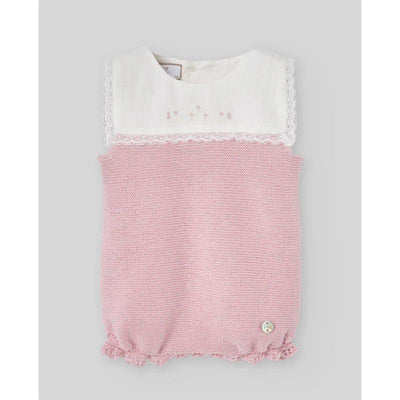 Knit newborn romper in chalk pink, featuring a white lace-trimmed collar and button detail at the bottom.