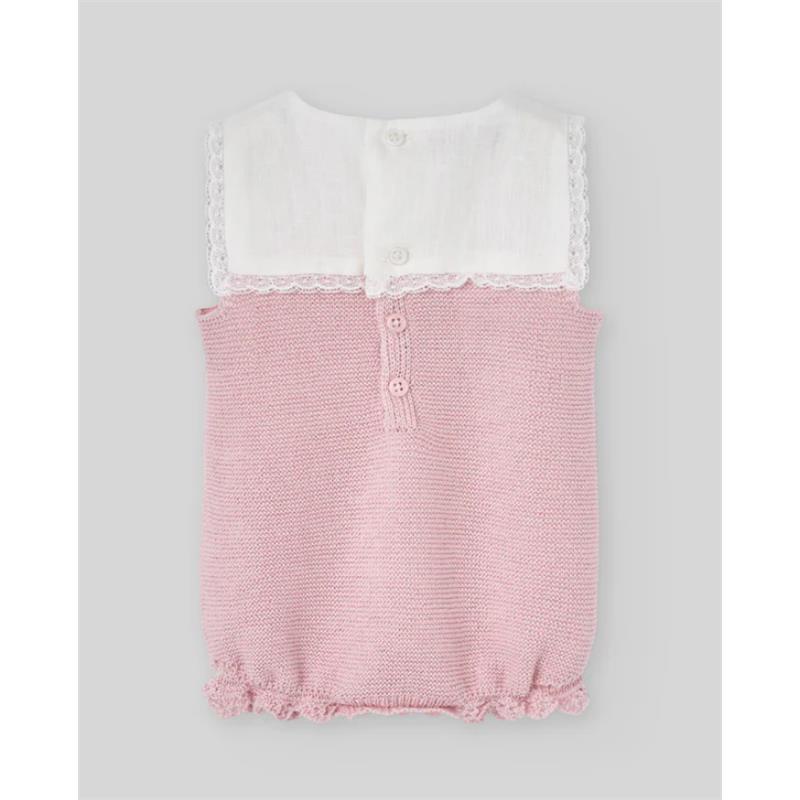 Knit newborn romper in chalk pink with a white lace-trimmed collar and three-button closure at the back.