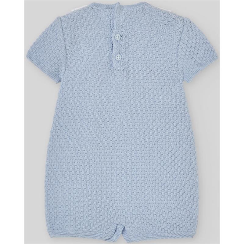 Knit newborn romper in sky blue with a textured pattern and button closure at the back.