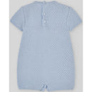 Knit newborn romper in sky blue with a textured pattern and button closure at the back.
