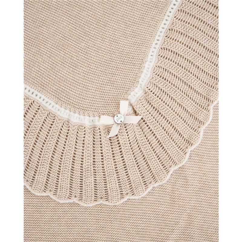 Knit newborn shawl in light brown and cream, featuring a scalloped edge and a decorative ribbon with a button.