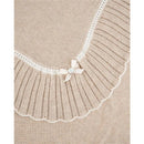 Knit newborn shawl in light brown and cream, featuring a scalloped edge and a decorative ribbon with a button.