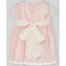 Woven infant girl dress in powder pink with lace short sleeves and a white satin belt. Suitable for ceremonies.
