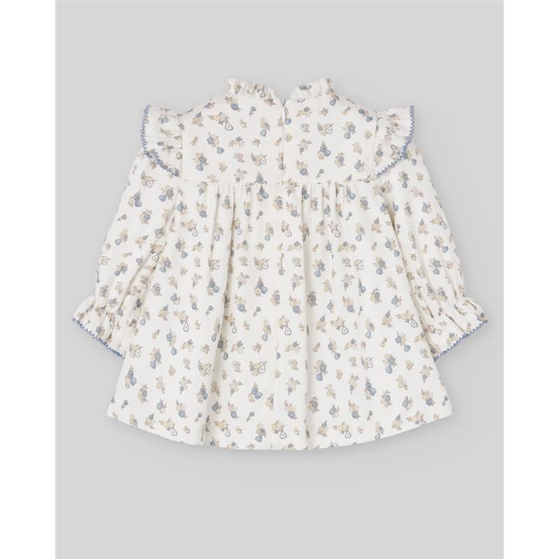 Woven newborn dress by Paz Rodriguez in cream with blue floral patterns and ruffled sleeves.