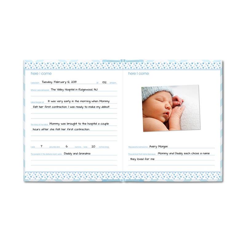 Blue Pearhead Baby First 5 Years Memory Book open to pages detailing birth information with a photo of a sleeping baby in a knit cap.