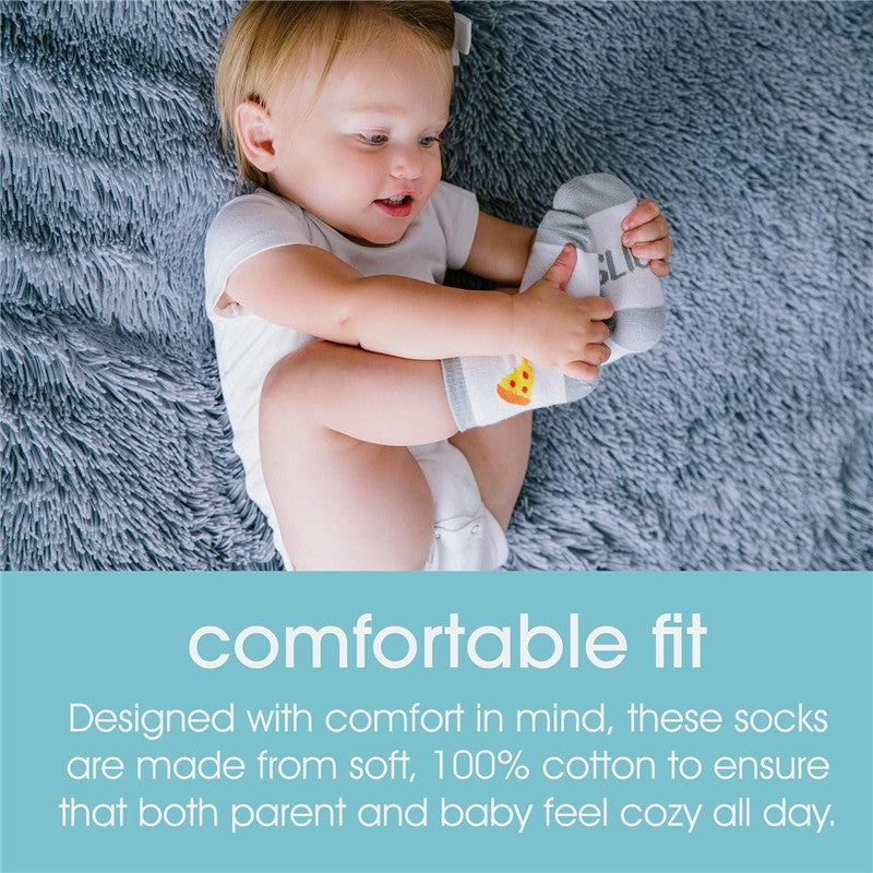 Matching gray socks with pizza slice designs worn by a smiling toddler on a soft textured surface.