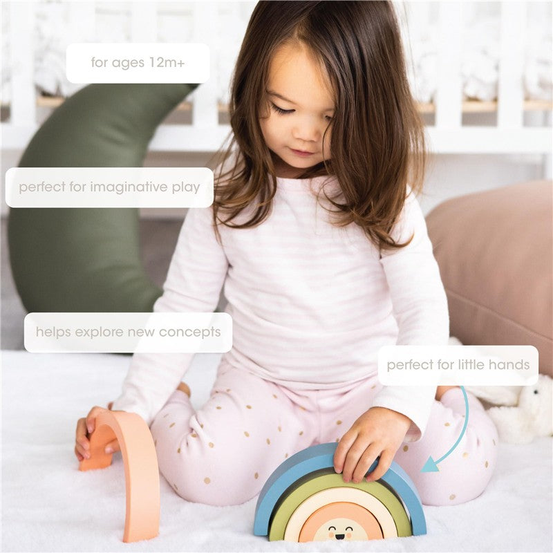 Wooden rainbow stacking toy displayed with a child, featuring pastel colors and a smiling face, designed for imaginative play.