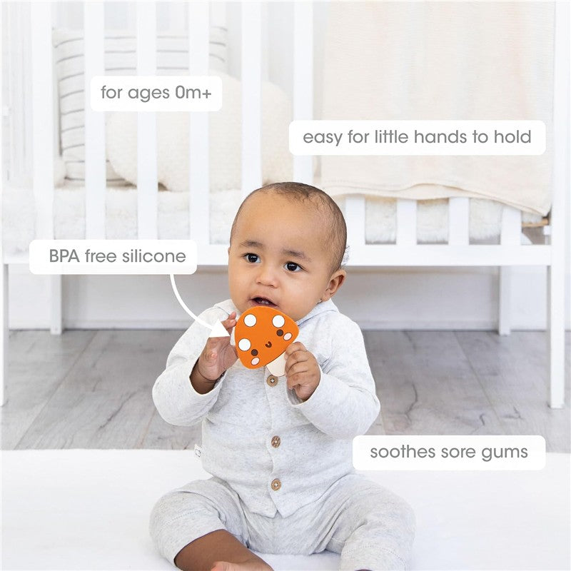 A baby holds a pearhead mushroom-shaped silicone teether in orange to soothe sore gums, designed for ages 0+.