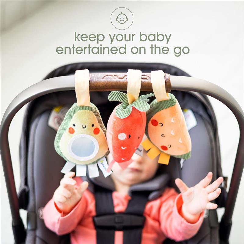 Stroller toy set of three plush fruit toys—a strawberry, avocado, and pineapple—hang from a stroller, captivating a baby below.