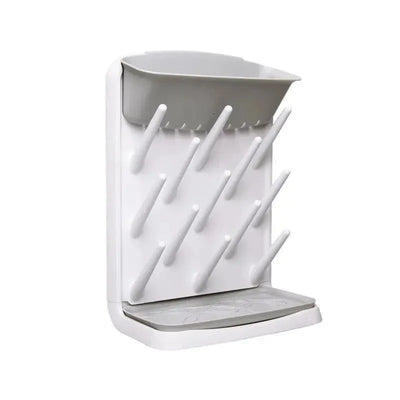 Ubbi Vertical Baby Bottle Drying Rack in gray, featuring multiple drying pegs and a removable drip tray.
