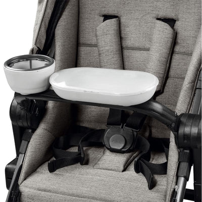 White tray and cup holder attached to a Ypsi stroller, designed for child convenience during outings.