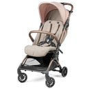 Volo Ultra Lightweight Carry On Compliant Travel Stroller by Peg Perego in beige and pink, featuring a harness and storage basket.