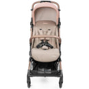 Compact Peg Volo stroller in Mon Amour (Rose Gold) with a beige seat, safety harness, and a stylish design.
