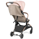 Compact Peg Volo stroller in Rose Gold with a beige seat and a black storage basket, shown from the back.