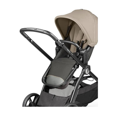 Peg YPSI Single-to-Double Stroller in Vanilla Blend, featuring a tan canopy and black seat fabric, suitable for infants and toddlers.