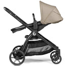 Single-to-double stroller in Vanilla Blend, featuring a beige canopy, adjustable seat, and black frame with storage basket.