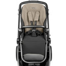 Peg YPSI Single-to-Double Stroller in Vanilla Blend, featuring a padded seat, harness, and a modern design.