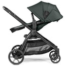 Single-to-double stroller in sage green with adjustable canopy, black frame, and ample storage basket underneath.