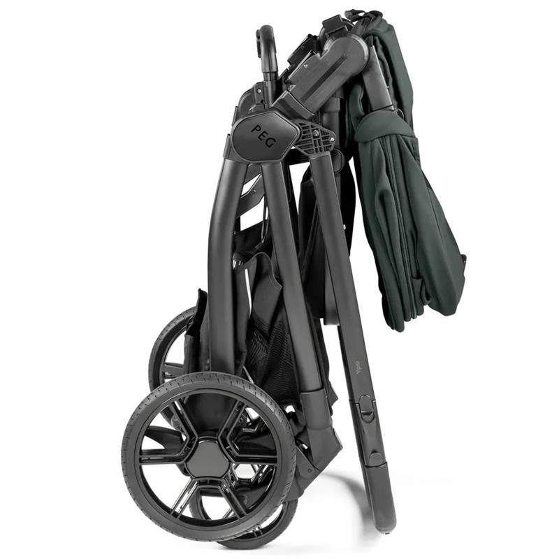 Peg Ypsi single-to-double stroller in sage green, folded with a sleek metal frame and black wheels.