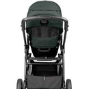 Travel system stroller with a dark green canopy and a spacious storage basket beneath.