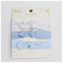 Three blue jersey headbands for babies from Piccolo Bambino, featuring a mix of plain and patterned designs on a display card.