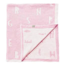Feather chenille blanket in pink with alphabet pattern, displayed on a wooden hanger.