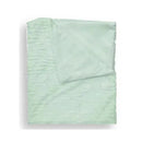Textured faux fur stroller blanket in green with a soft finish, displayed on a wooden hanger.