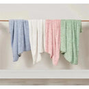 Textured faux fur stroller blankets in pink, blue, white, and green, draped over a wooden hanger.