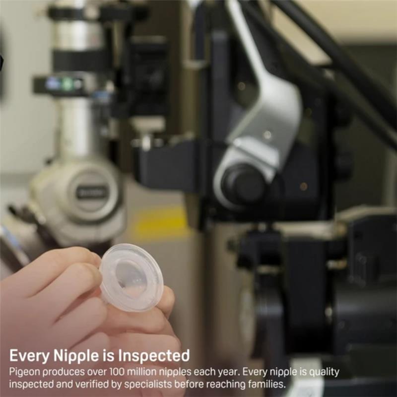 Silicone nipple held in a hand with inspection equipment in the background, highlighting quality control for Pigeon products.
