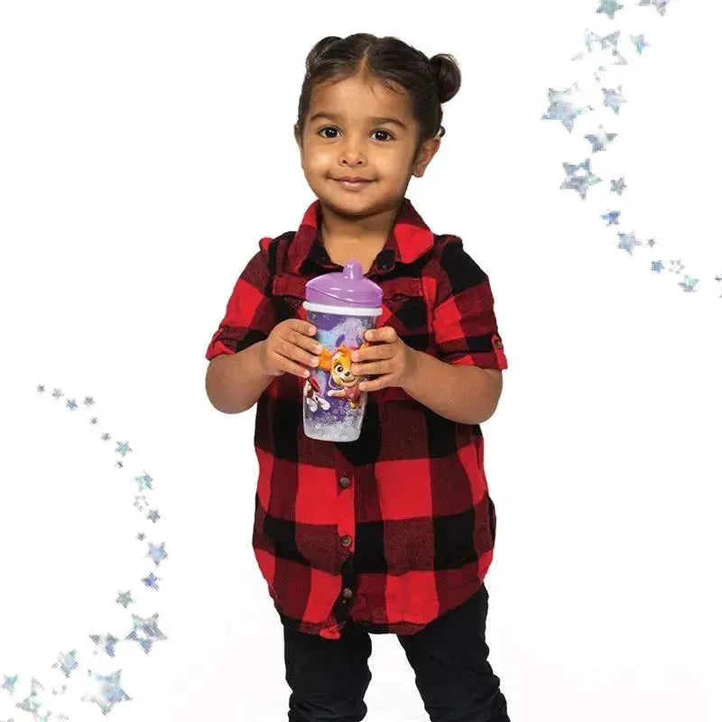 Toddler wearing a red and black plaid shirt holds a glittery PAW Patrol sippy cup with a purple lid.