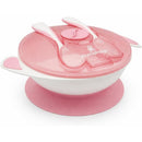 Primo Passi baby suction bowl with a light pink lid, fork, and spoon set, designed for easy feeding and minimal spills.