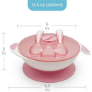 Light pink Primo Passi baby suction bowl with lid, fork, and spoon set, featuring a non-slip base and a playful design.