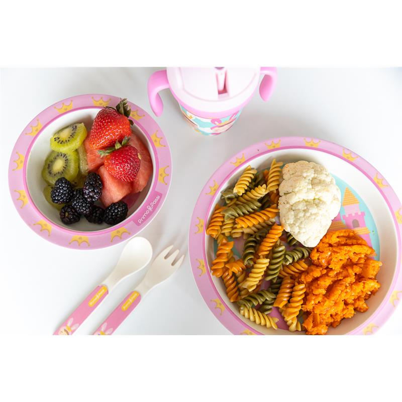 Bamboo fiber divided plate with colorful pasta, cauliflower, and sweet potatoes; accompanied by a fruit bowl and utensils.