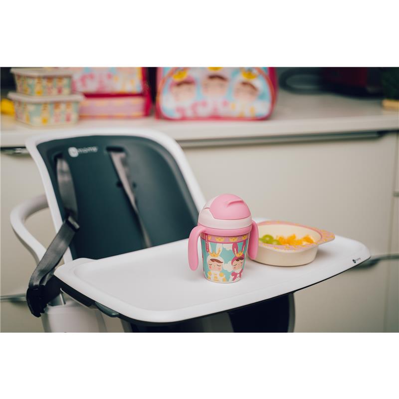 Bamboo fiber kids’ dinnerware set featuring a divided plate, bowl, cup with handles, and fruit salad on a high chair tray.