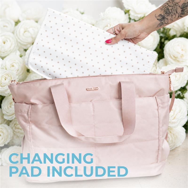 Black Primo Passi diaper bag with a changing pad partially visible, set against a background of white roses.