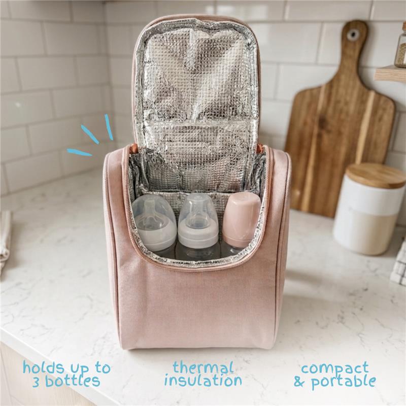 Insulated pink bottle bag with thermal lining, featuring three compartments for baby bottles, on a kitchen counter.