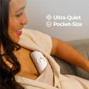 Lactation massager Primo Passi showcased on a woman’s chest, with a focus on its ultra-quiet, pocket-size design.