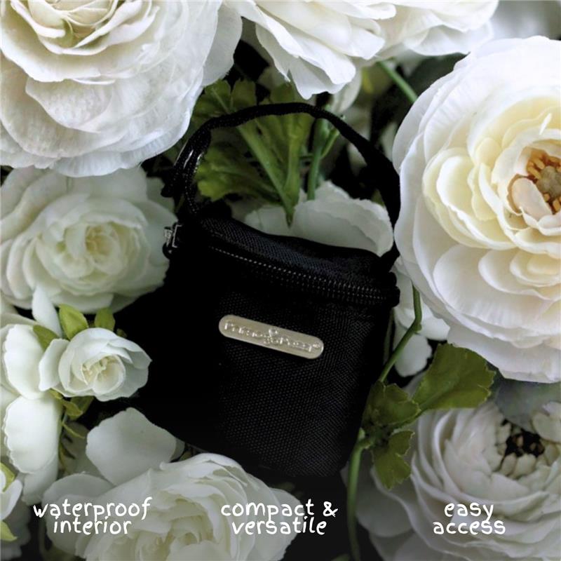 Black primo passi pacifier bag surrounded by white flowers, featuring waterproof interior, compact design, and easy access.
