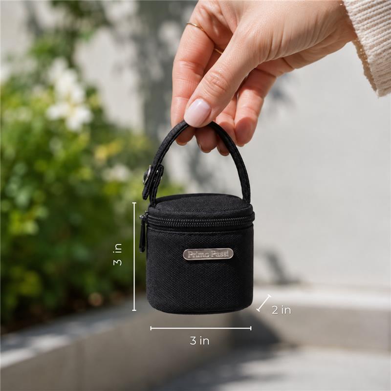 Compact black Primo Passi pacifier bag, featuring a zipper and handle, held in a hand with dimensions shown.