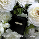 Primo Passi pink pacifier bag with waterproof interior, surrounded by white flowers, highlighting compact design and easy access features.