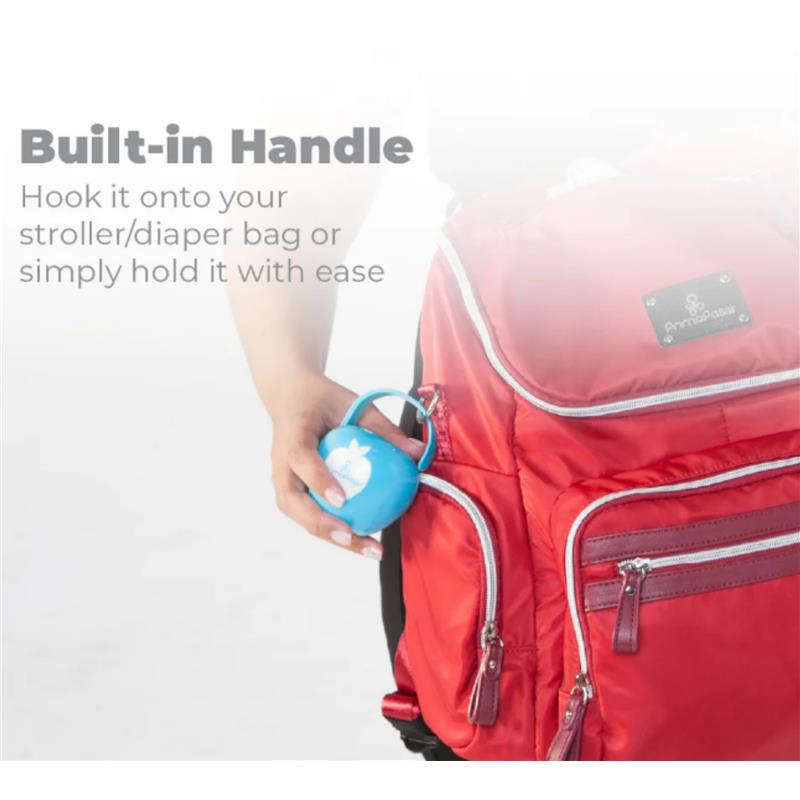 Blue Primo Passi pacifier case being held near a red diaper bag, highlighting its built-in handle feature.