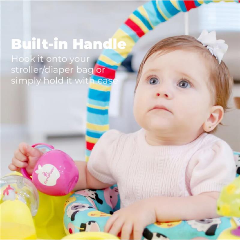 Primo Passi pacifier case in pink, held by a baby, featuring a built-in handle for portability.