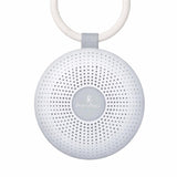 Portable white noise machine by Primo Passi, featuring a round design, speaker holes, and a hanging loop for easy attachment.