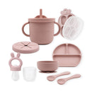 Rose pink baby feeding set including silicone carrot freezer, food feeder, spoon 2-pack, suction bowl, plate, training cup, and snack cup.
