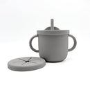 Grey silicone training cup with two handles and a lid, accompanied by a matching suction plate.