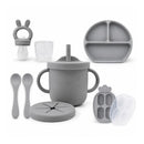 Silicone feeding set in senior grey, including a training cup, suction bowl, plate, spoons, and freezer container.