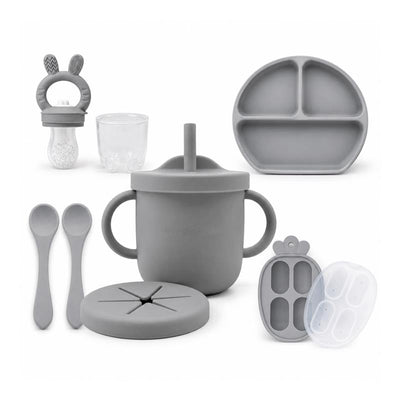 Silicone feeding set in senior grey, including a training cup, suction bowl, plate, spoons, and freezer container.