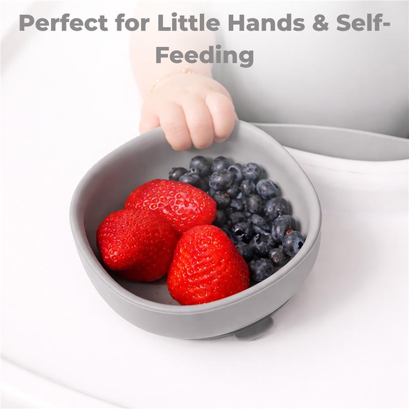Suction bowl with strawberries and blueberries, designed for little hands to promote self-feeding.