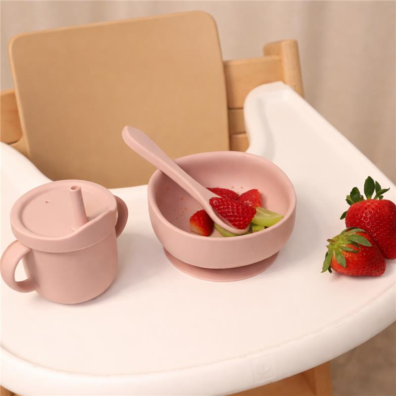 Silicone suction bowl in dusty blue with strawberries and celery, alongside a matching cup, on a high chair tray.